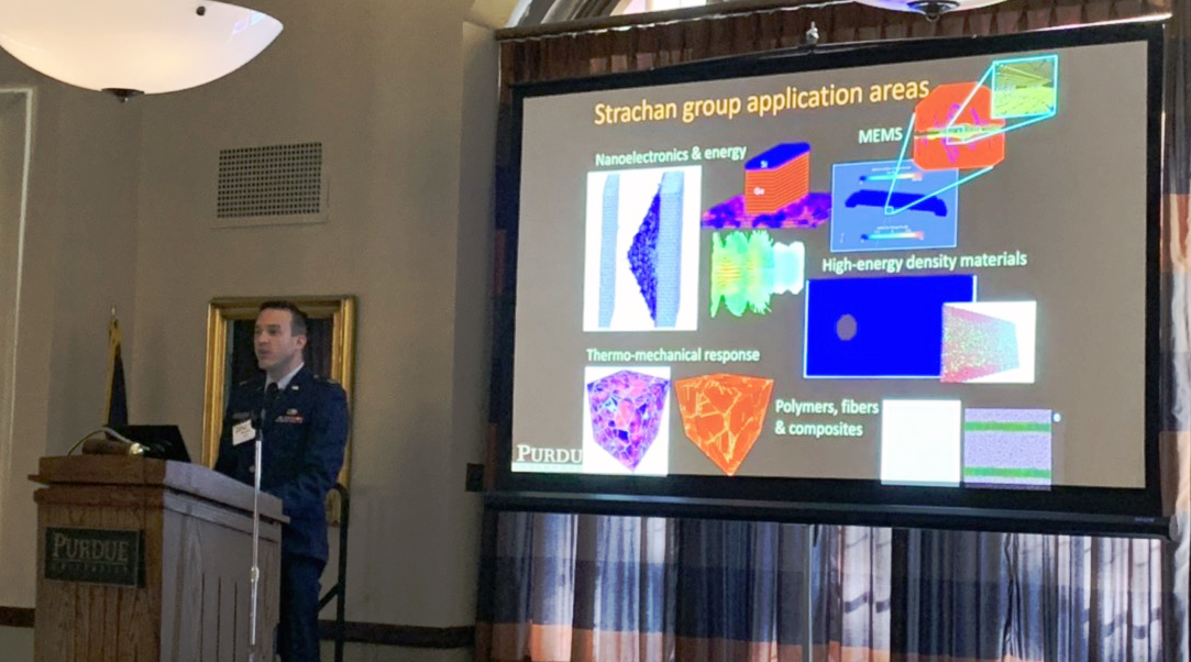 Timothy Wolf presenting next to projected image